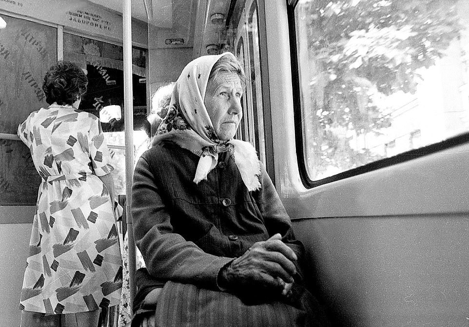#33 Public Transport: A woman looks wistfully out of a window while passing through Kyiv, 1999.