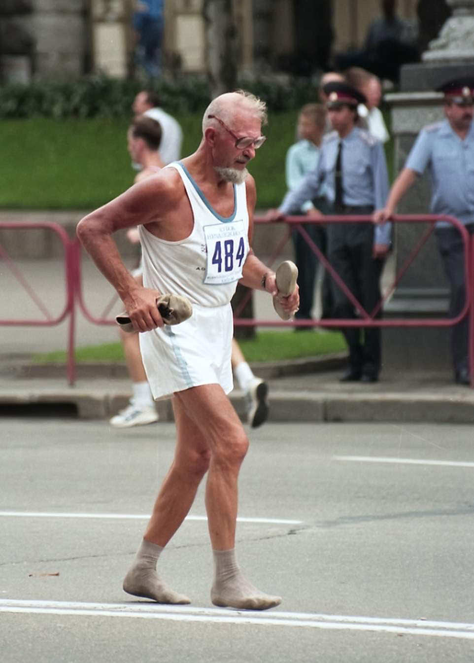 #52 Shoeless Race: Man finishes a race barefoot, demonstrating determination, 1998.