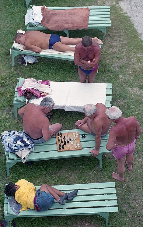 #58 Chess at the Pool: Men in swim shorts pause for a game of chess, 1998.