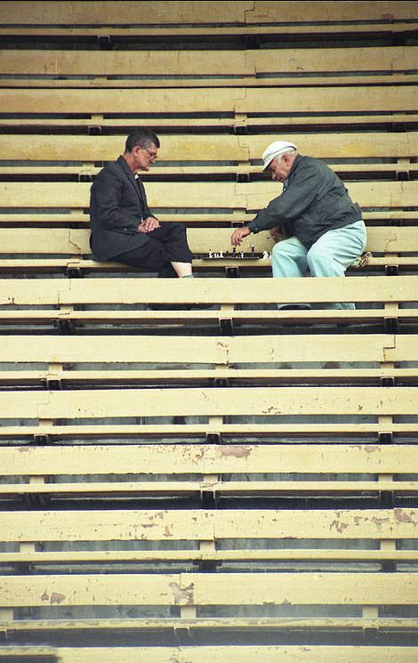 #59 Stadium Chess: Two men play chess after the football stands empty, 1999.