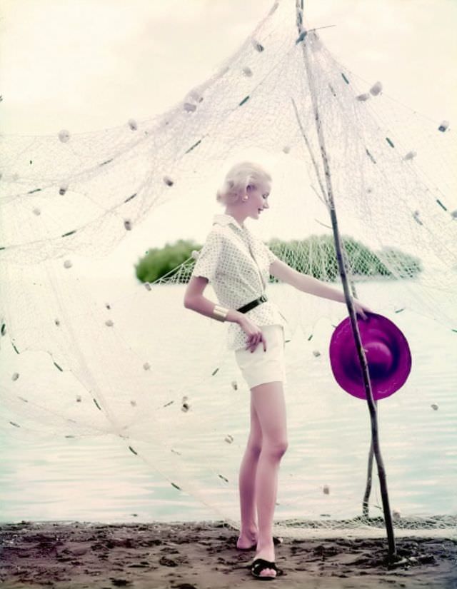 #9 Sunny Harnett in a polka-dot blouse paired with white shorts and a black belt, 1954.
