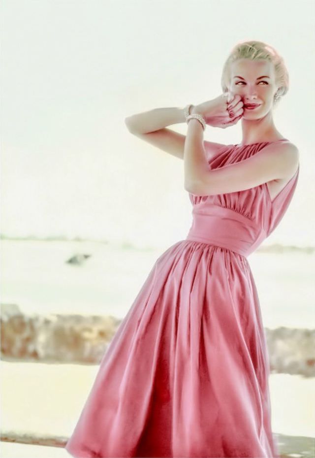 #10 Sunny Harnett wears a rose-pink summer dress with a molded empire midriff and drawstring bodice, 1954.