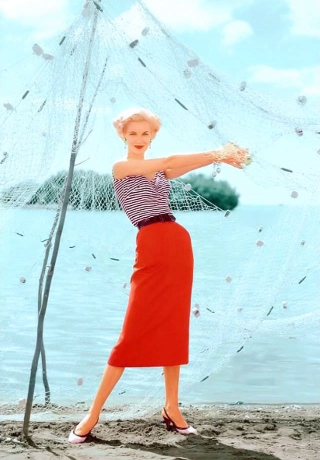 #11 Sunny Harnett in a black and white striped top paired with a slim red skirt, in Puerto Rico, 1954.