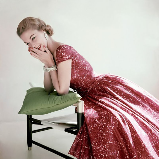 #14 Jean Patchett in a red and pink floral print cotton chiffon dress by Adele Simpson, 1955.