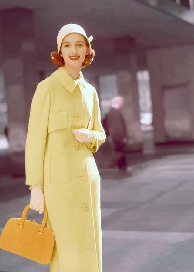 #15 Joan Romano wears a yellow wool coat by Swansdown and accessories by multiple designers, 1955.