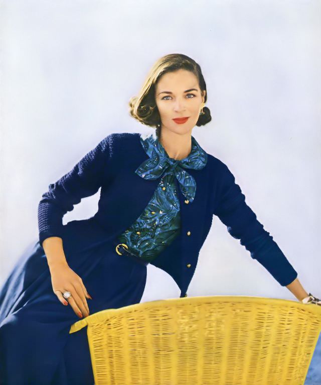 #20 Theo Graham in a blue popcorn stitch cardigan jacket and print ensemble by Masket Bros., 1955.