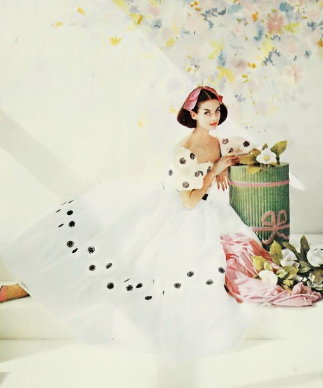 #35 Anne St. Marie in a white organdy dress bordered with embroidered daisies, 1959.