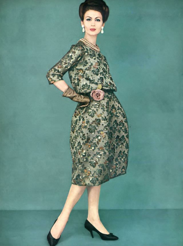 #37 Isabella Albonico in a taupe velvet dress with bas relief designs by Pierre Cardin, accented by diamond earrings, 1959.