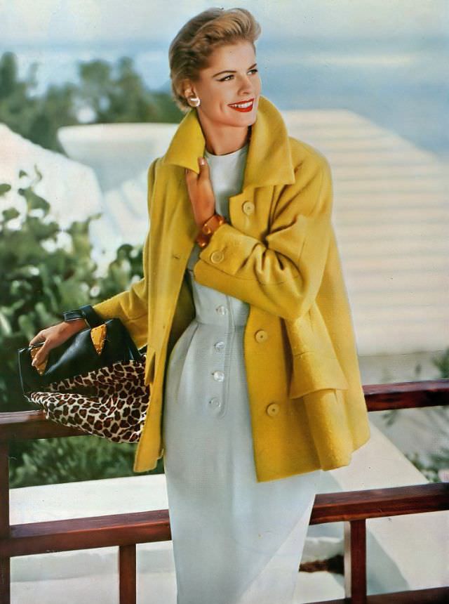 #5 Model wears a lemon-yellow tweed coat by Lo Balbo over a white raw-silk sheath by Branell, 1954.