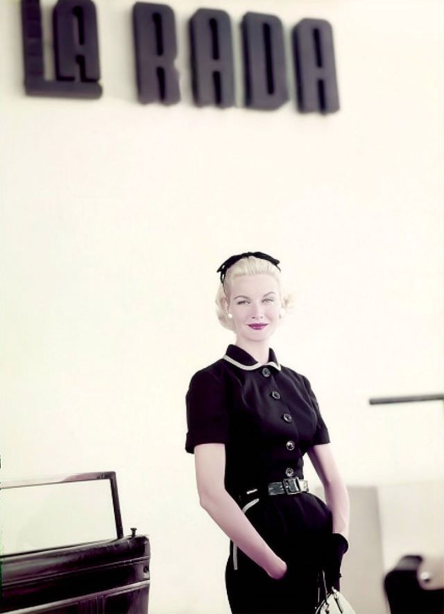 #7 Sunny Harnett sports a black linen dress with gingham-trimmed collar and pockets, belted in black patent leather, in Puerto Rico, 1954.