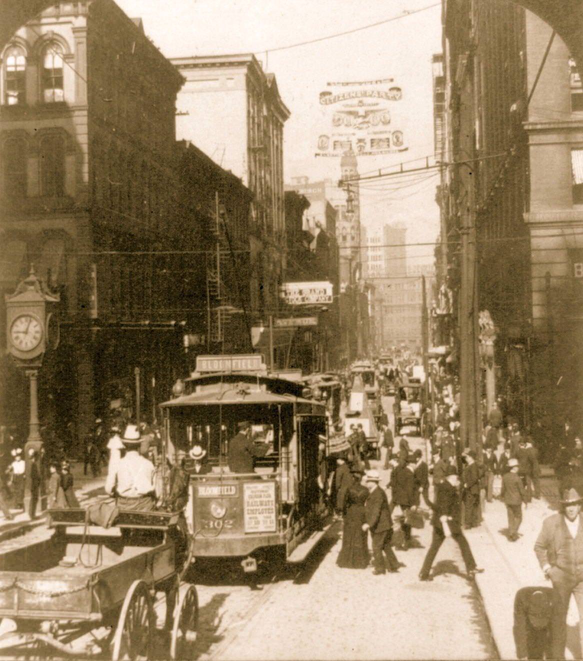 #4 Bustling 5th Avenue west from Smithfield in Pittsburgh, featuring trolley cars and pedestrians, 1903.