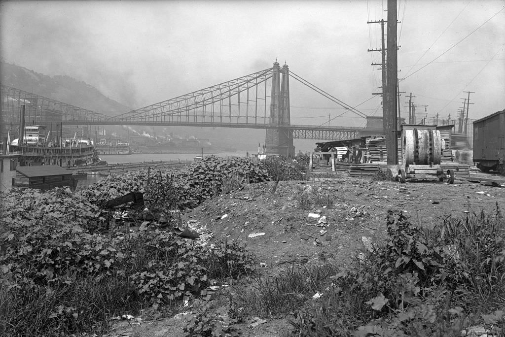 #144 Riverside Scene with bridge and riverboats, 1910s