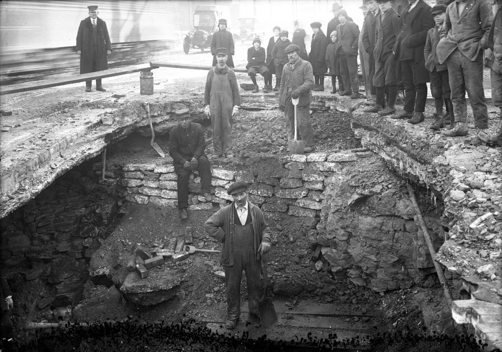 #104 Men working on break, washout visible, 1920.