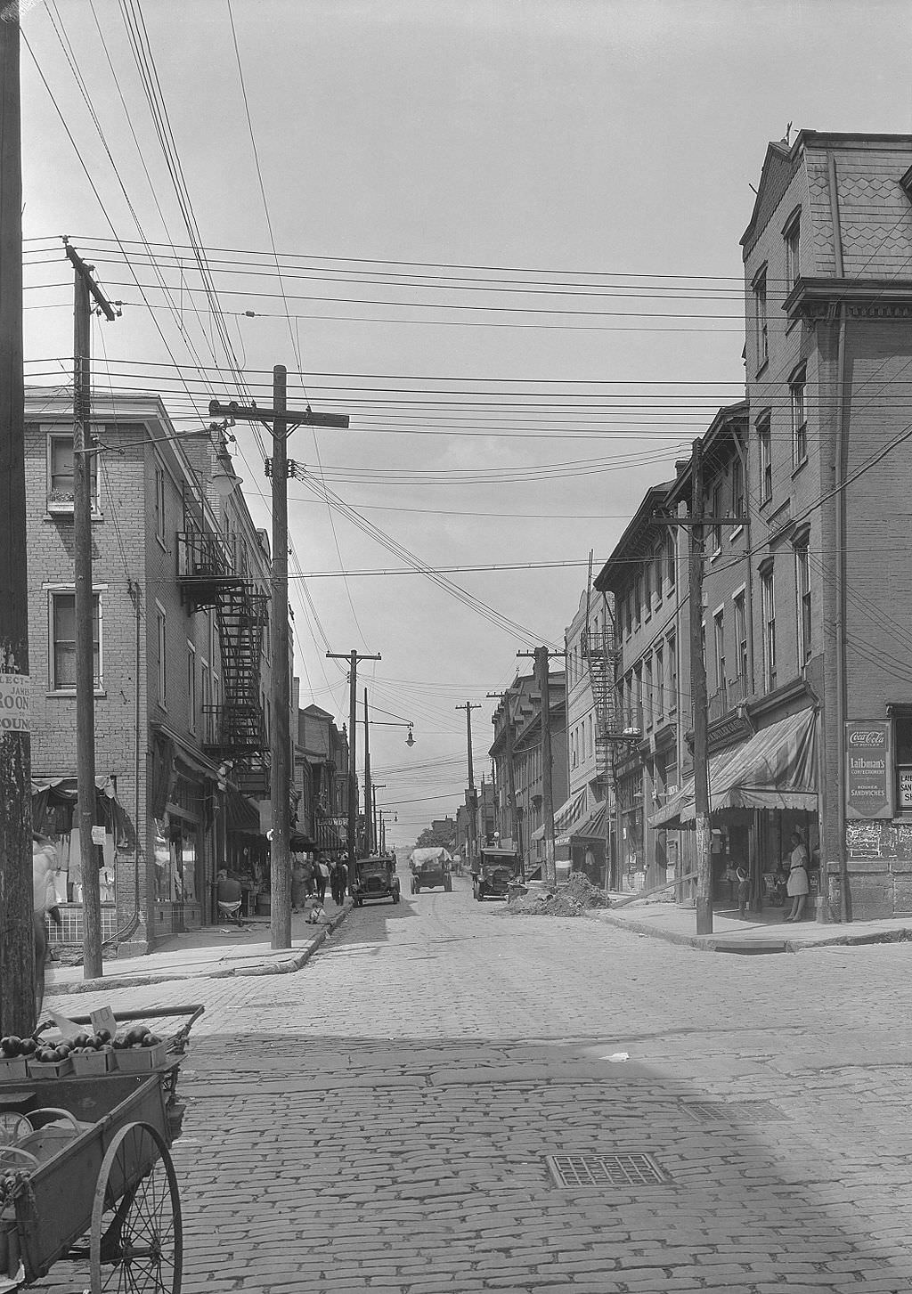 #105 Logan Street from Epiphany, Laibman’s Confectionery on right, 1931