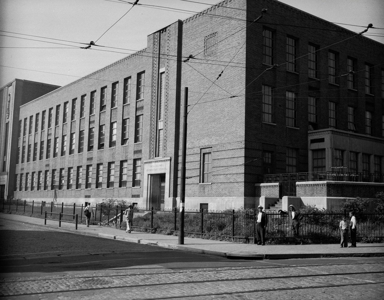 #36 A Leo Weil Elementary School Exterior with Four People, 1946