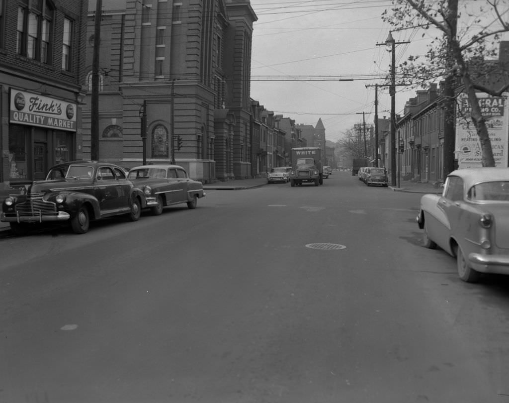 #118 Sarah Street at the intersection with South 22nd Street featuring Fink’s Quality Market and Saint Casimir Church, 1956
