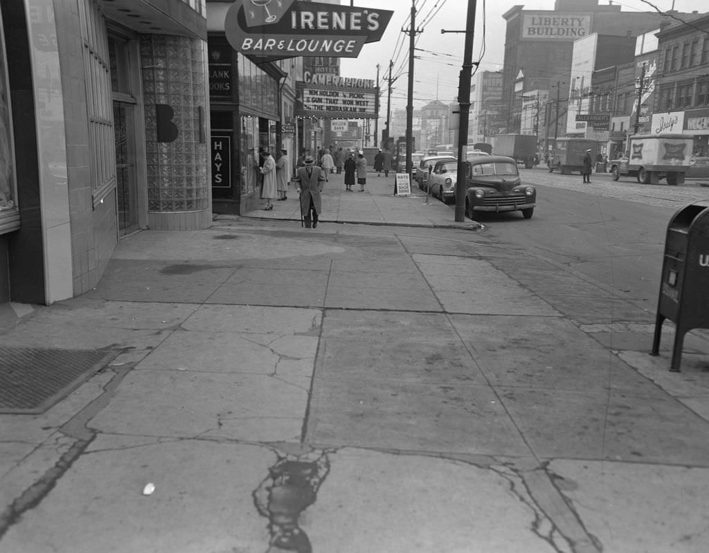 #120 Penn Avenue in East Liberty showcasing the Liberty Building, Irene’s Bar and Lounge, Cameraphone, and Isaly’s, 1957