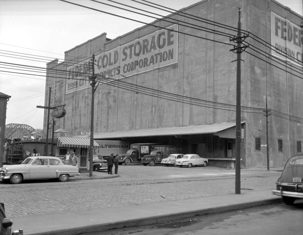 #134 Federal Cold Storage building featuring a busy loading dock and diner, 1955