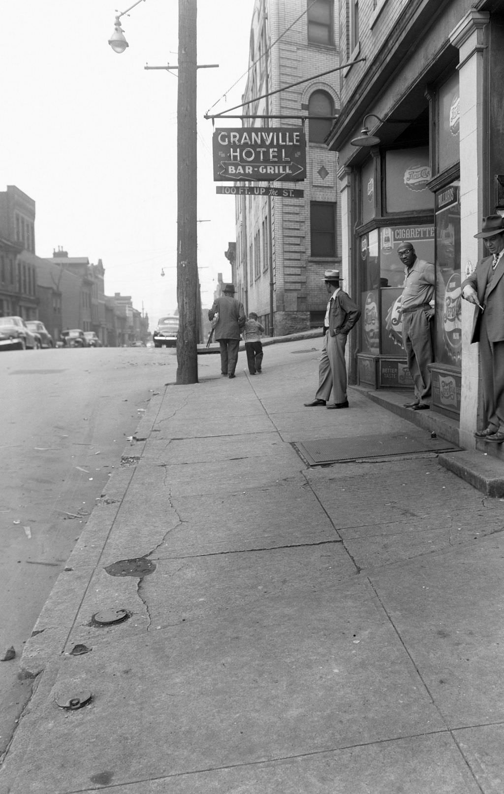 #3 Man standing near Granville Hotel Bar and Grill on Wylie Avenue, 1954.