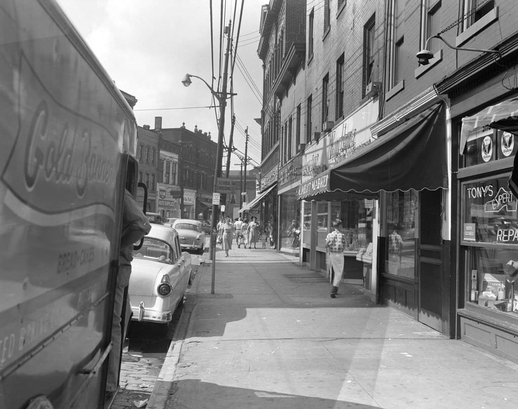 #72 Butler Street view showing pedestrians and parked Gold Banner truck, 1955.