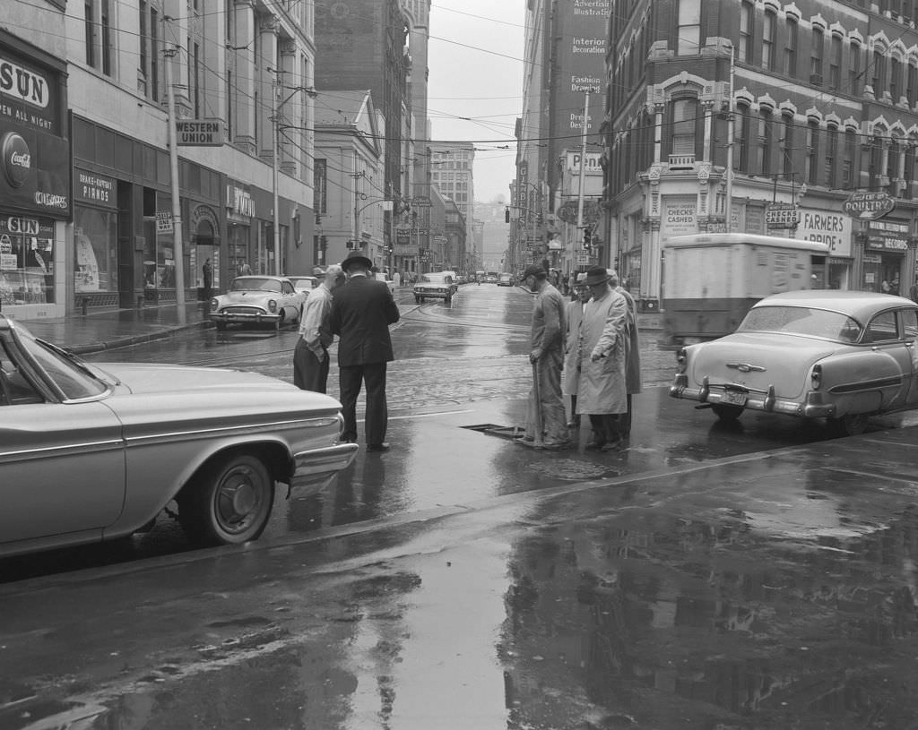 #106 Liberty and Smithfield Streets, men near a manhole, Gimbel’s Department Store visible, 1961.