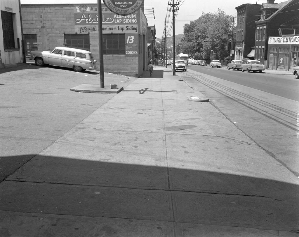 #126 Penn Avenue, long view with trolley car and businesses including Triangle Electronics, 1960.