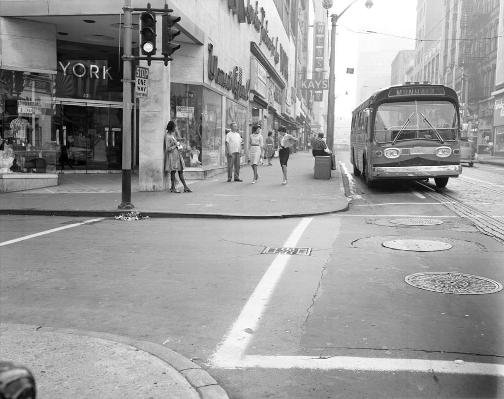 #137 York Women’s Apparel on Fifth Avenue, bus for Munhall at the curb, 1963.