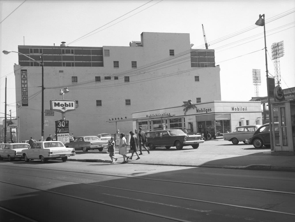 #18 Matthew’s Building in Oakland: Mobile gas station and Forbes Field lights in the distance, 1966.