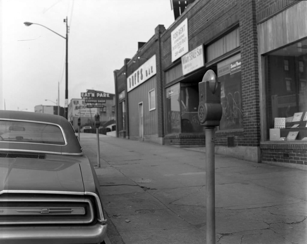 #76 Graffitied commercial property and local bar on Penn Avenue, 1970.