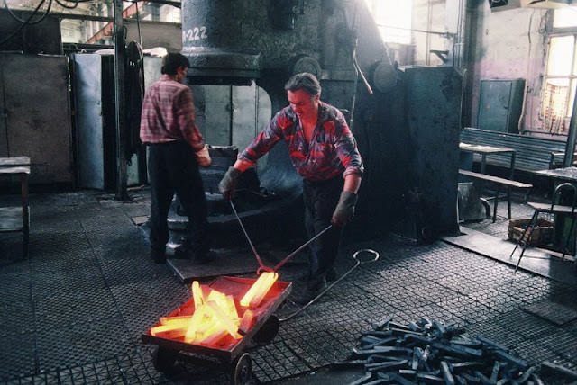 #49 Workers forge metal bars at the Lviv Bus Plant (Lvivsky Avtobusny Zavod, or LAZ), Lviv, Ukraine, 1991