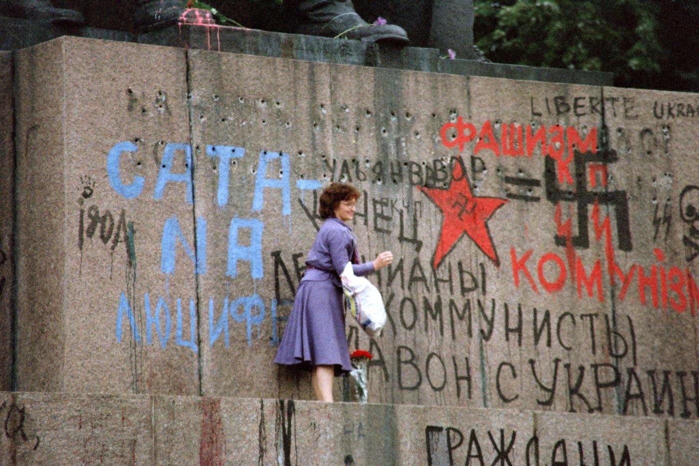 #46 Woman Stands on Graffiti-Covered Lenin Monument Pedestal in Kiev, 1991