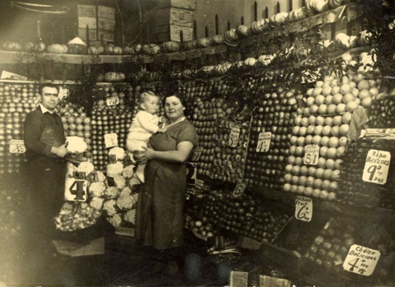 #35 Man, woman, and child in a fruit and vegetable shop