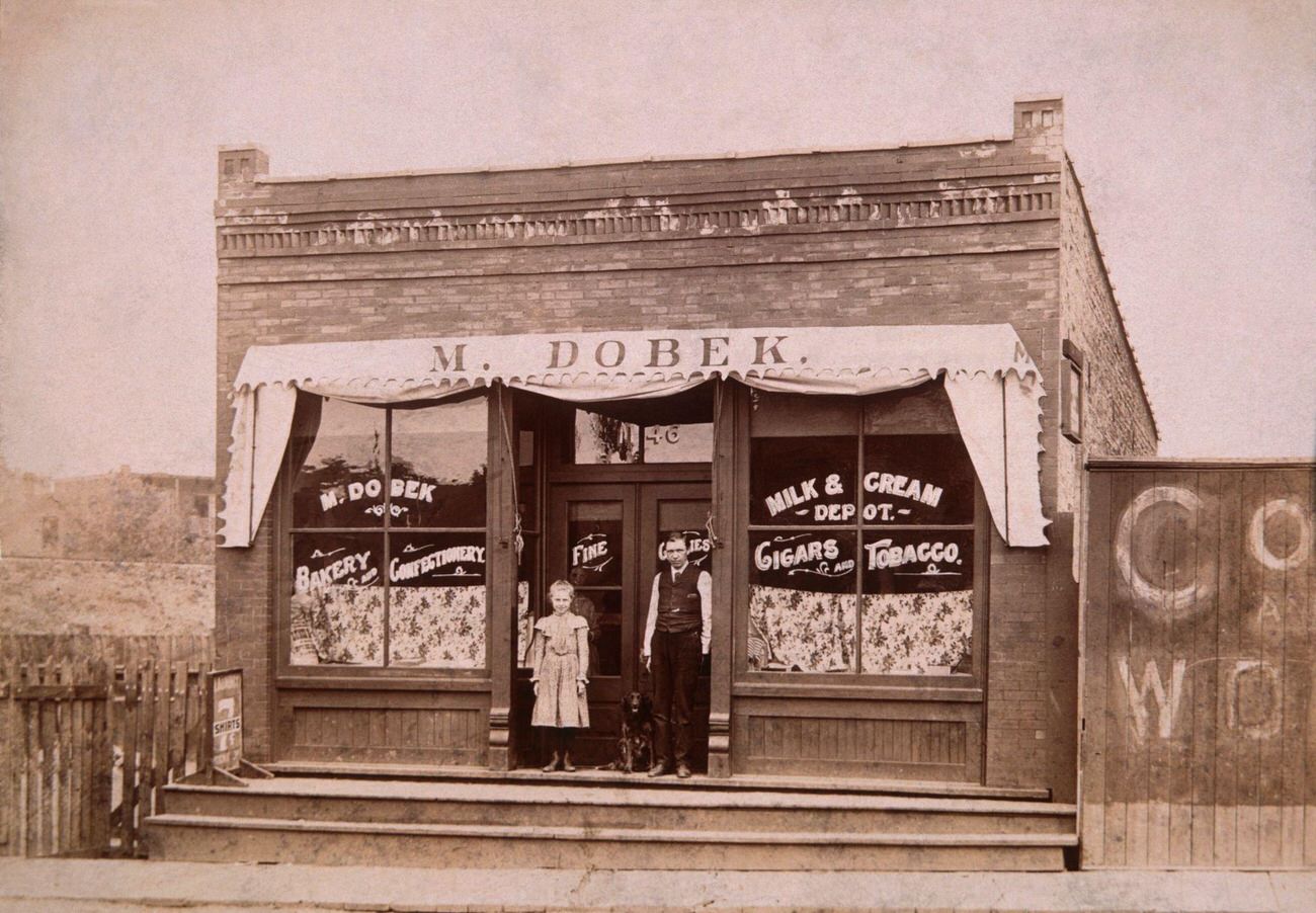 #1 Girl, Dog, and Man Outside Store, 1900