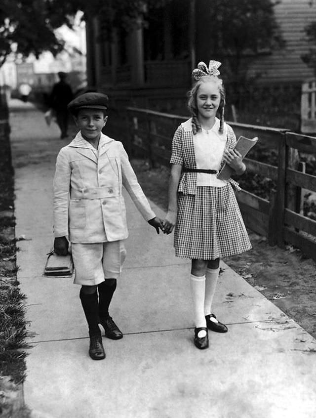 #1 A young boy and girl on the way to school for the start of a new term in the 1920s