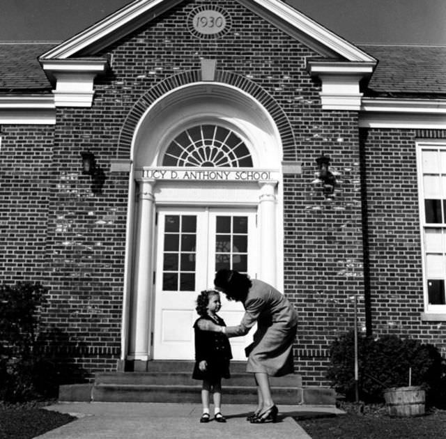 #13 In 1948, a young girl shares a moment with her mother outside the Lucy D. Anthony school in Madison, New Jersey