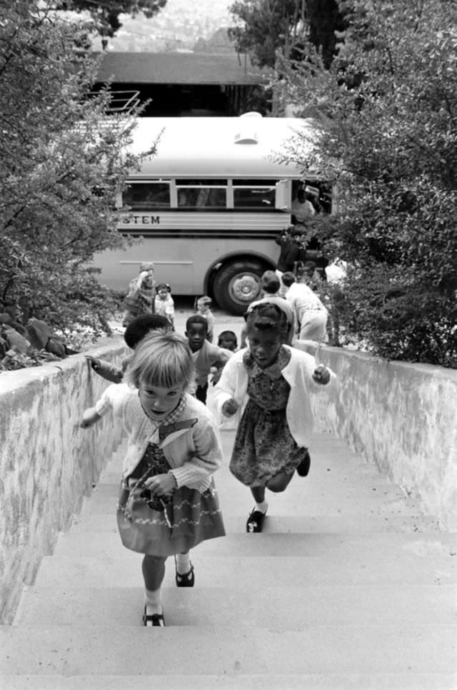#26 Children walk up a flight of stairs to attend a newly desegregated school in Berkeley, California, 1968