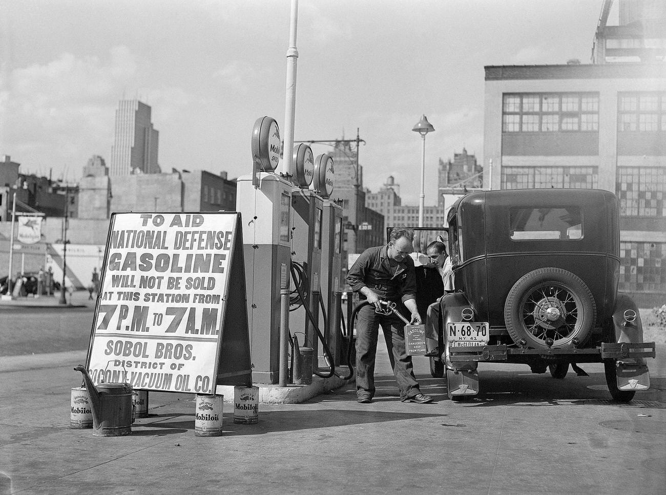 #13 Gas attendant fills spare cans at New York City gas station complying with Governmental Conservation Edict, 1941.