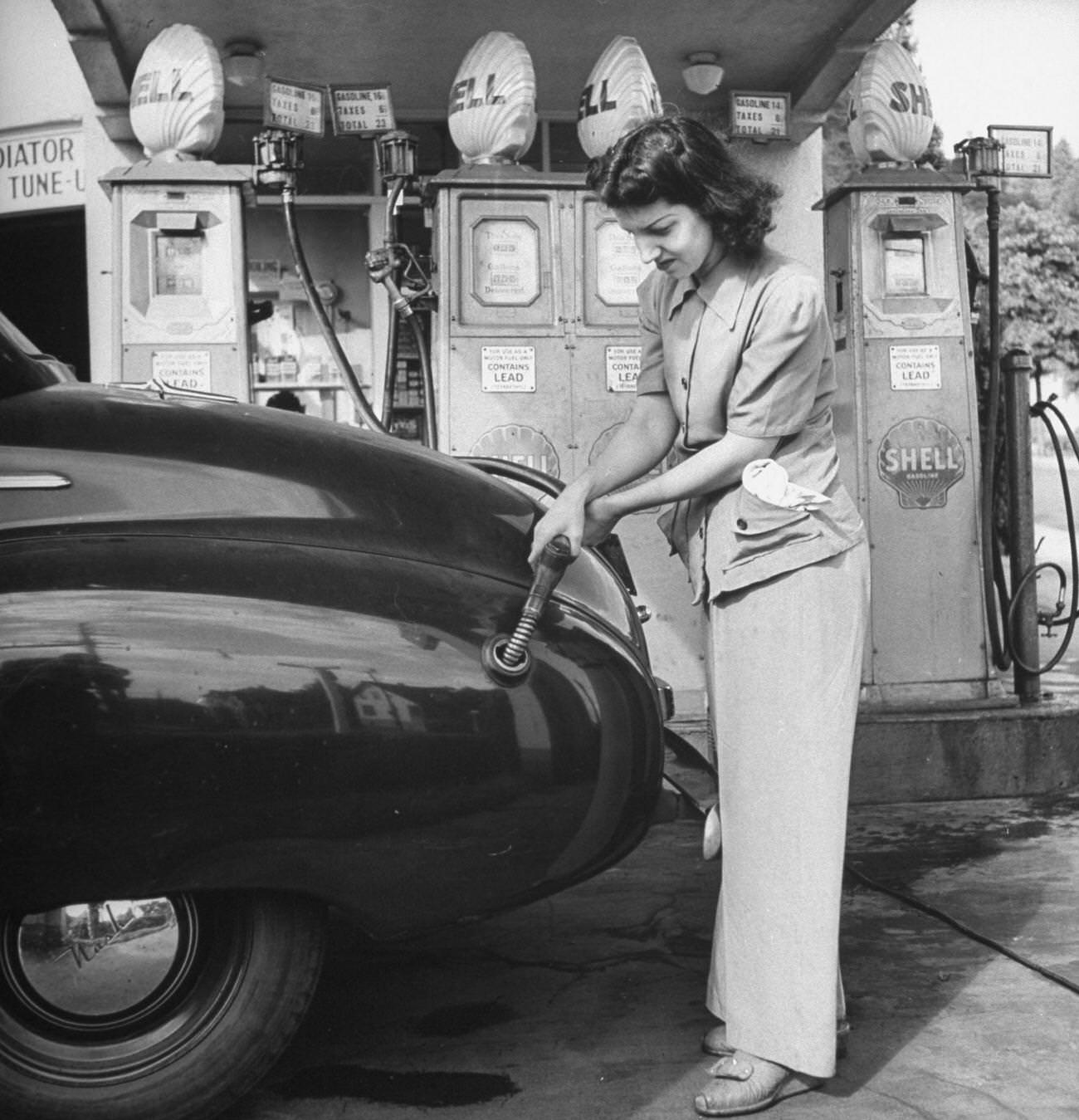 #16 Woman replaces men in vital war industries, working at a gas station.