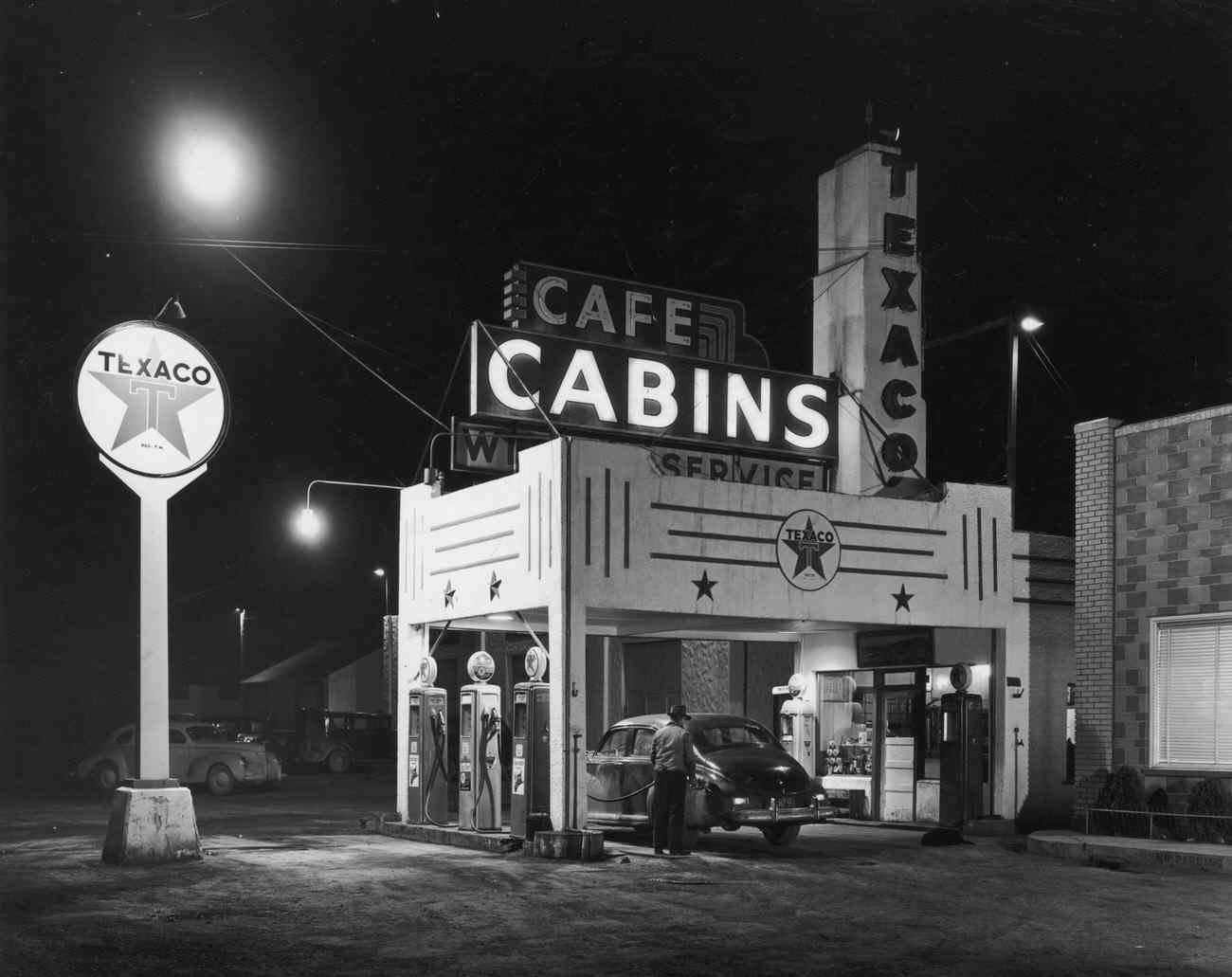 #19 Man fills gas tank at Texaco station and rest stop in Wendover, Utah.