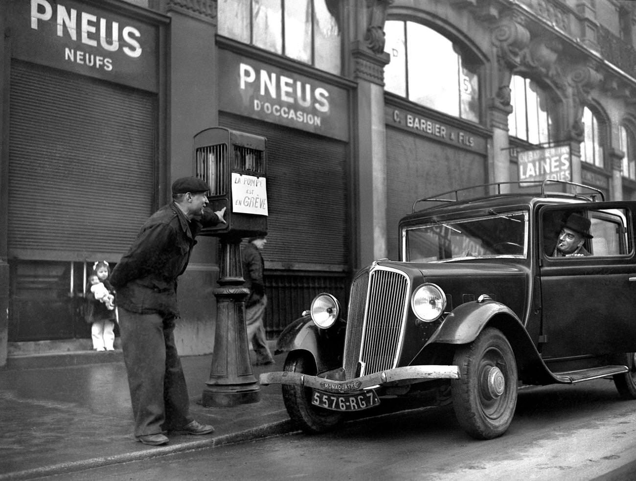 #24 Petrol pump attendant during gas stations strike in Paris, 1947.