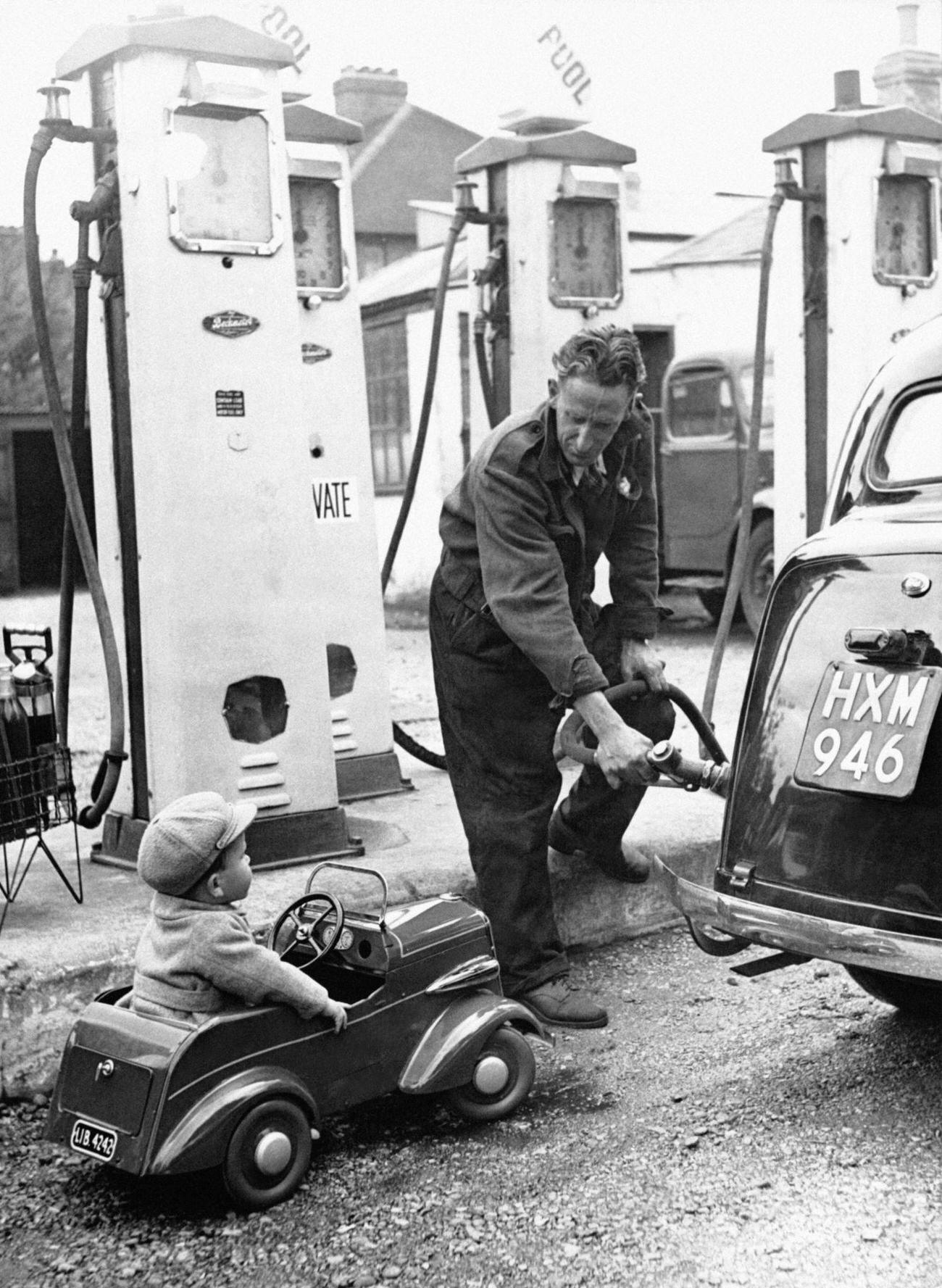 #75 Young Boy in Mini-Car Queuing at a UK Gas Station