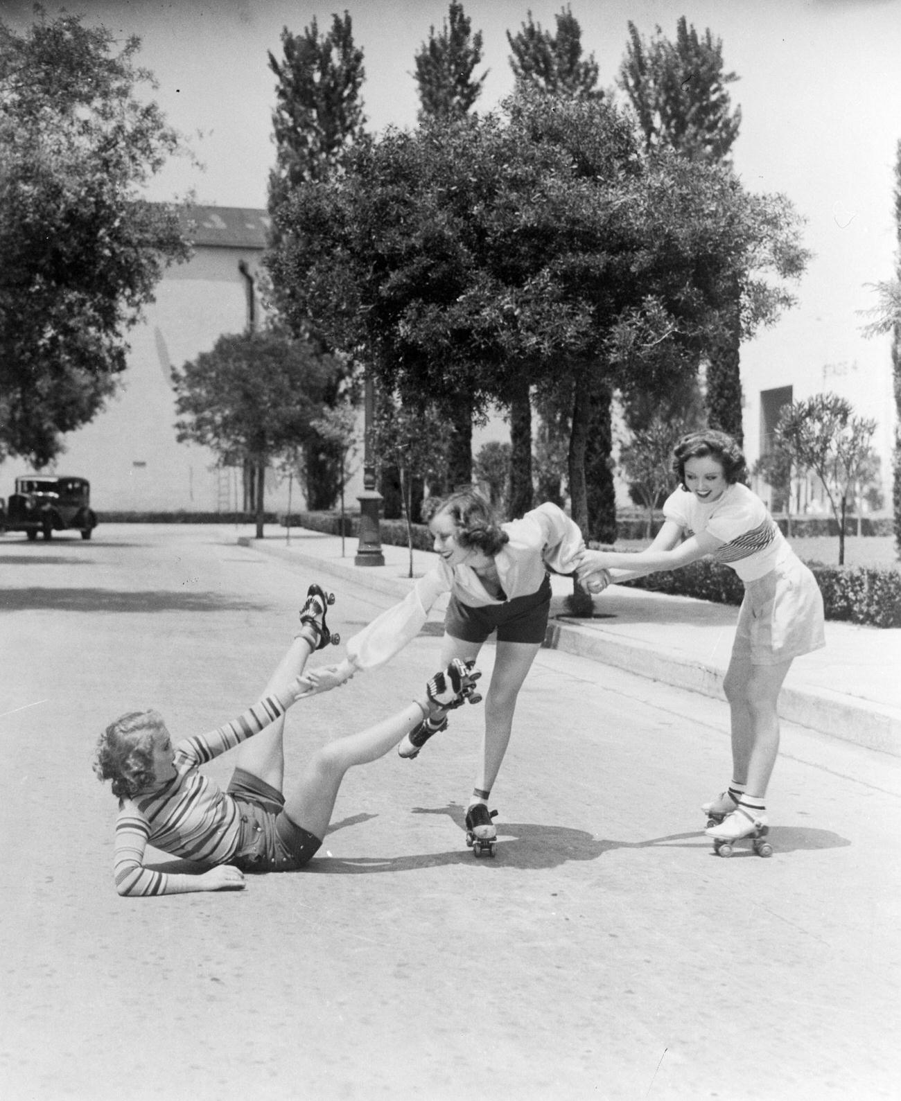 #6 Three Girls Roller Skating, One Being Helped After a Fall, 1933.