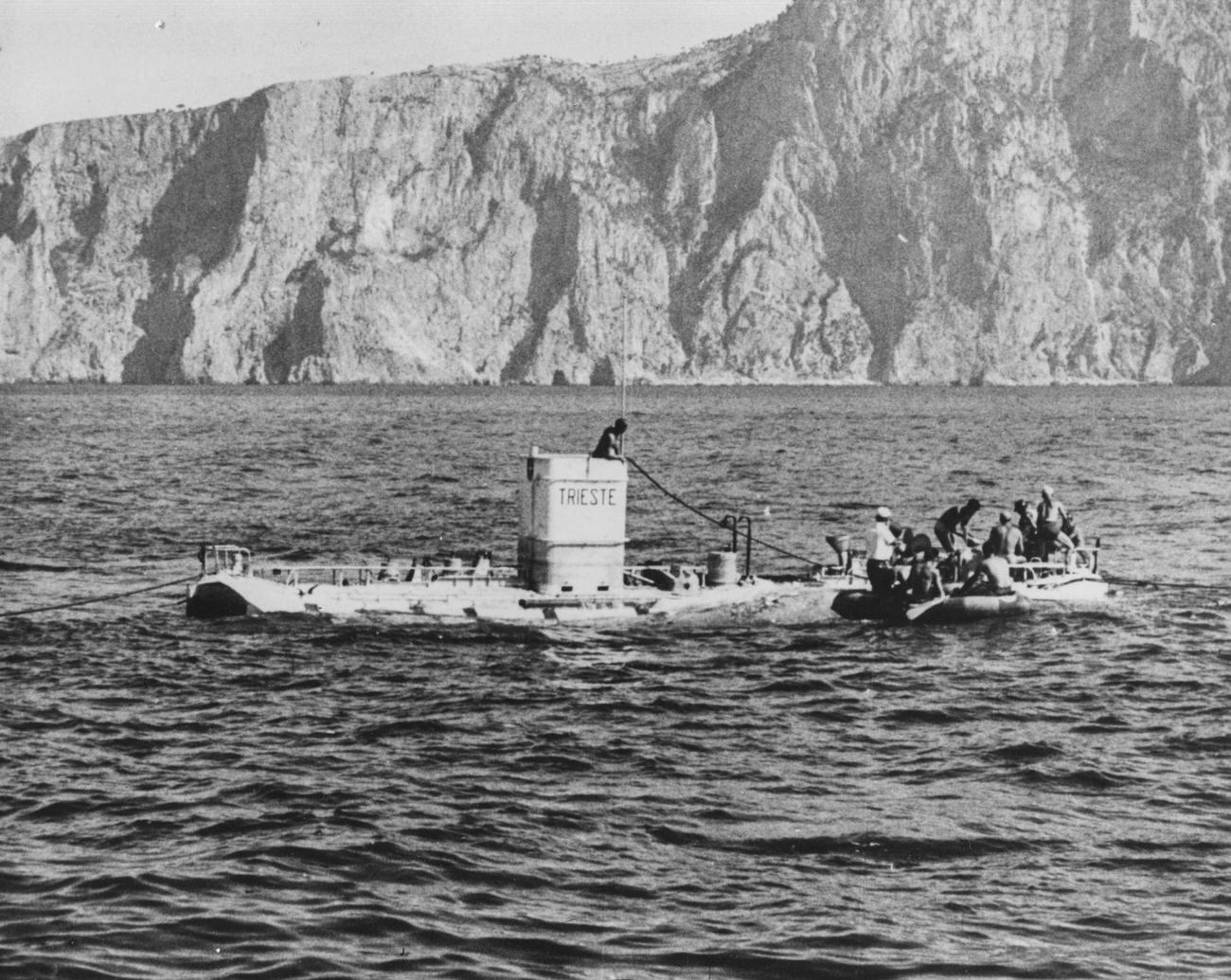 Auguste and Jacques Piccard boarding a rowing boat after surfacing in ‘Trieste’, 1953.
