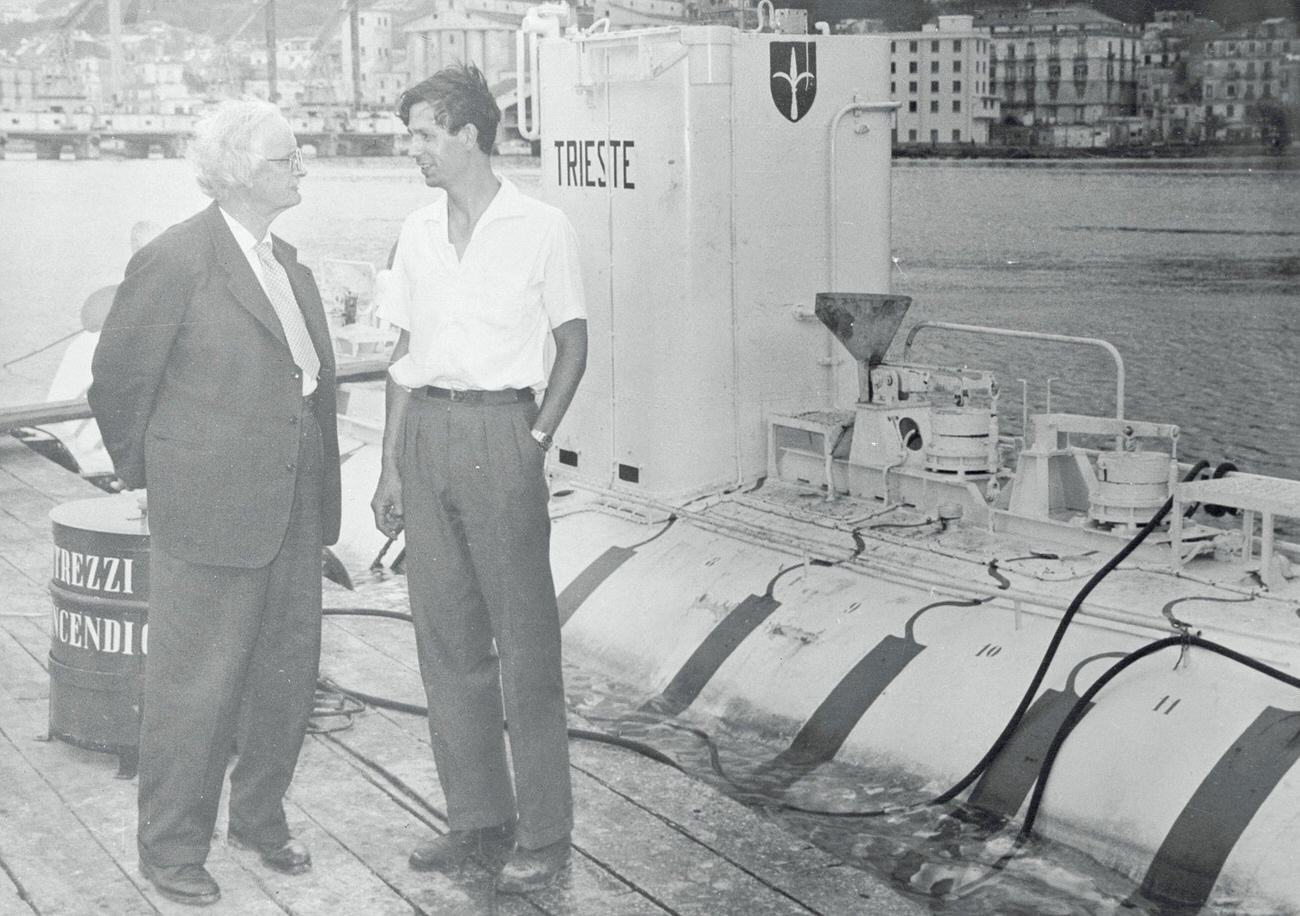 Jacques Piccard reaching a new sea depth of 12,460 feet with his father Auguste.