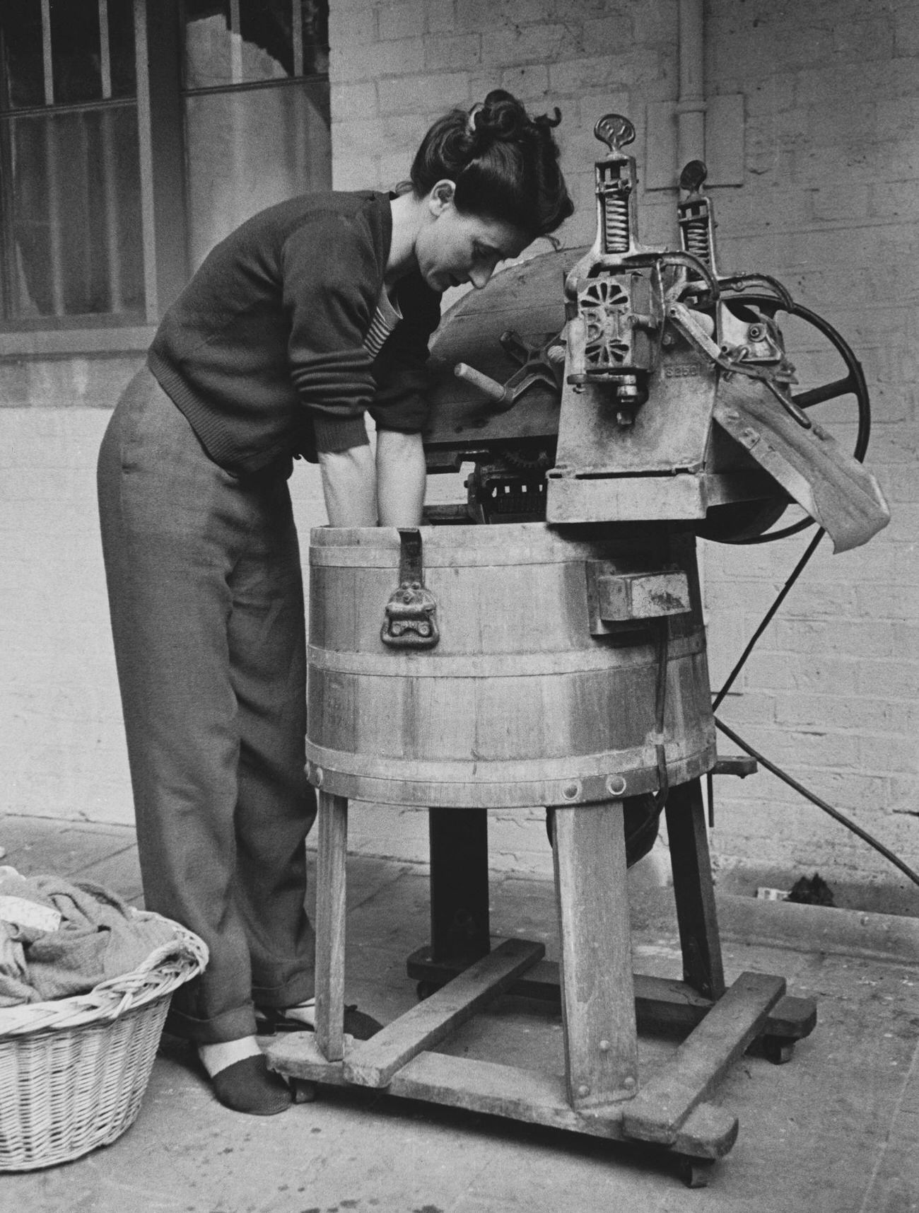 Woman using a washing machine.