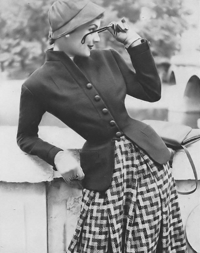 #4 Model in Madeleine de Rauch’s gray flannel and tweed outfit, Vogue, September 1, 1952.