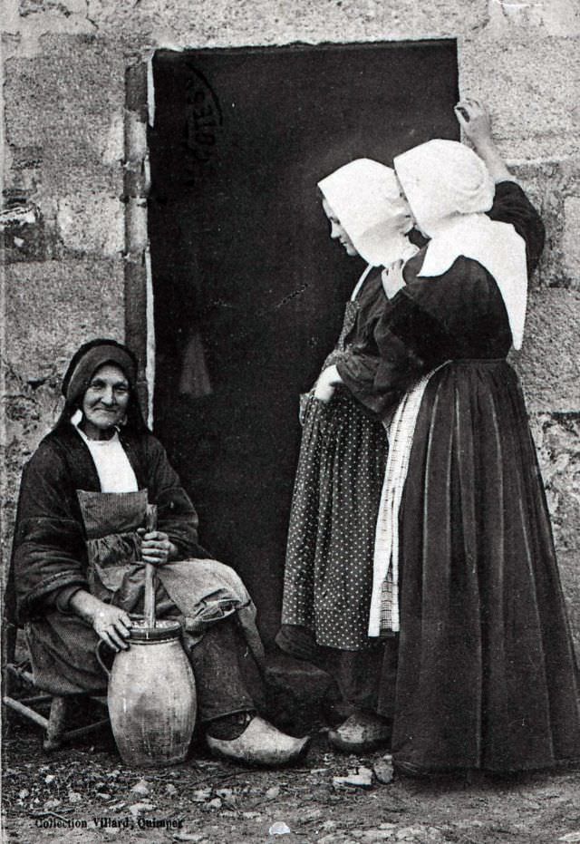 #1 Breton peasant women making butter with a hand churn.