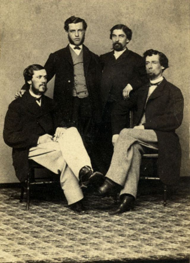 #26 Four men pose before the camera operator