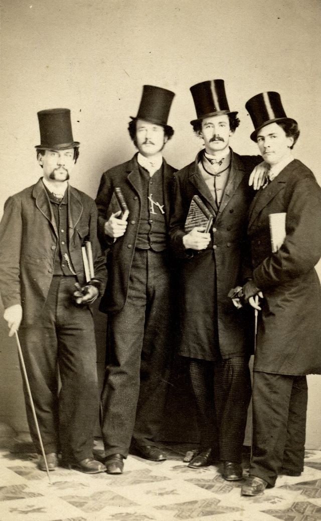 #28 Gents in top hats with canes, gloves and books stand for their group portrait