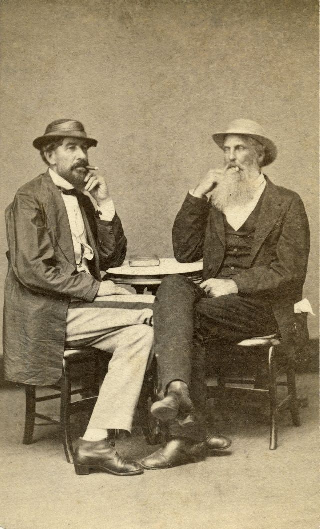 #34 These gents sporting straw hats enjoy cigars inside a photo studio along Canal Street in New Orleans